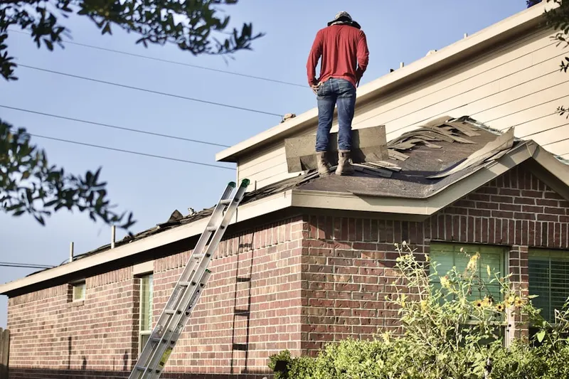 Professional roofer working on a residential roof in Winfield